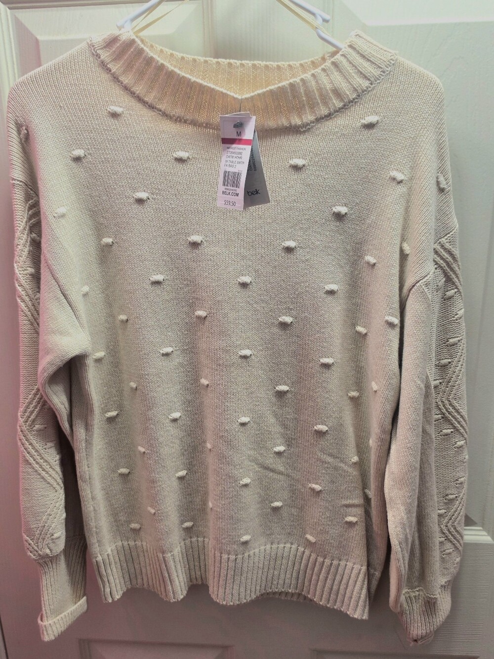 cozy cream knit sweater featuring an allover dimensional pom-pom pattern